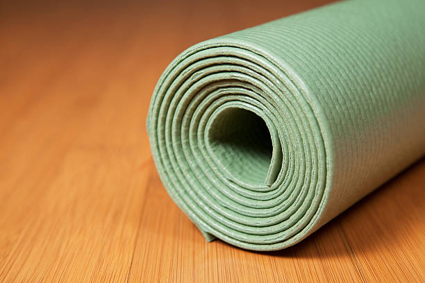 istock Rolled Green Yoga Mat on Bamboo Floor 175442545
