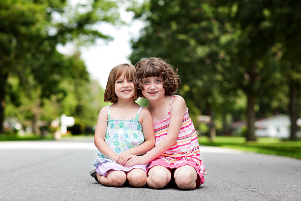 istock Two Happy Sisters Smiling and Hugging, in Outdoor Setting 175442729