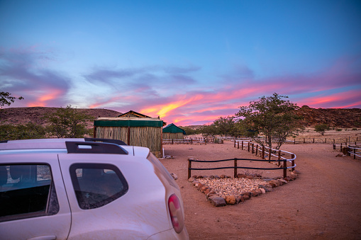 A colorful sunset over Xaragu Tented Camp, Damaraland, Namibia.  Horizontal.