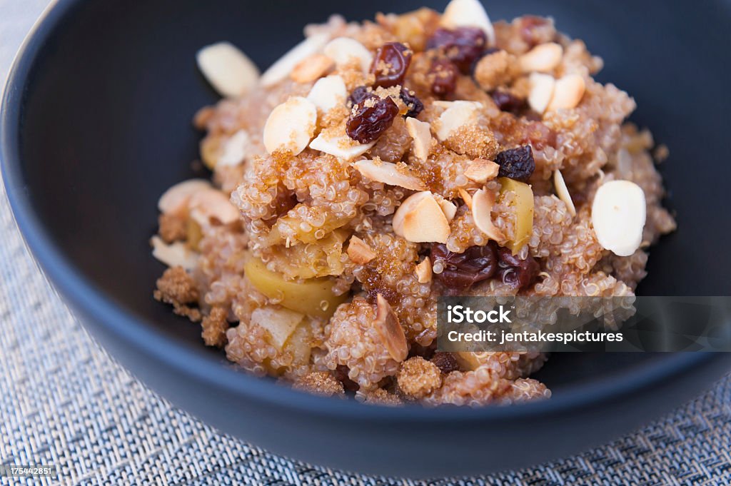 Black bowl of quinoa apple cereal "Cereal made with quinoa, apple, raisins, toasted almonds, cinnamon, and brown sugar." Quinoa Stock Photo