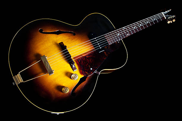 Vintage Sunburst Guitar Old guitar against black background. 1952 stock pictures, royalty-free photos & images