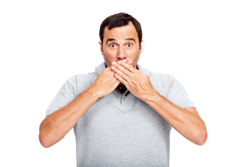 Shocked businessman holding his cheek isolated on white background