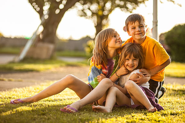 istock Bright Color Three Kids Grouped Smiling Neighborhood Lawn Soft 175444808