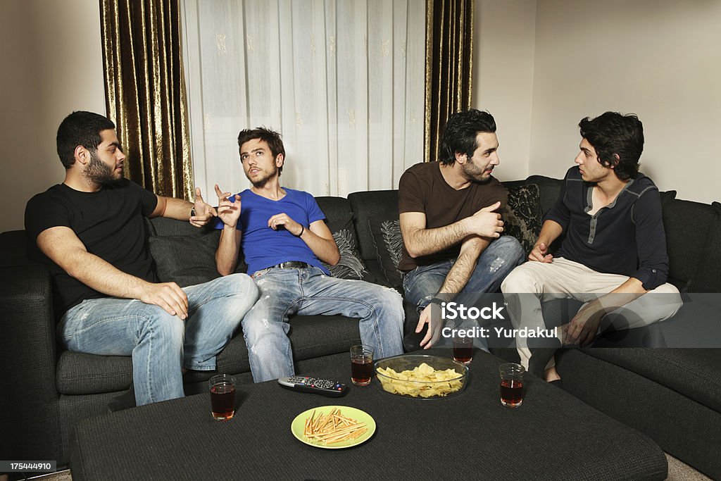 young men having a nice evening four young men enjoying a nice evening at homesimilar images: Adult Stock Photo