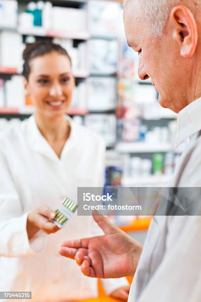 Pharmacist Giving Pills To A Customer Stock Photo - Download Image Now - Customer, Pharmacist, Active Seniors