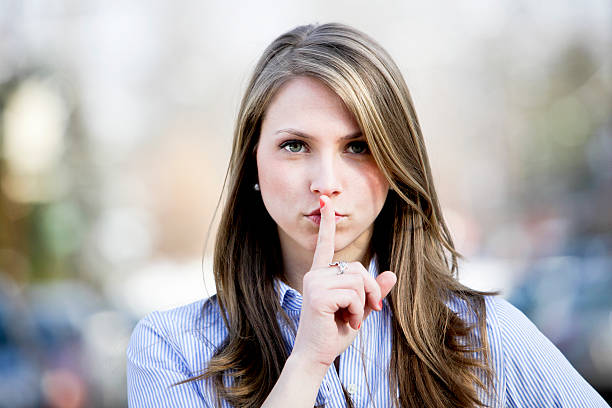istock Woman with Finger on Lips 175445509