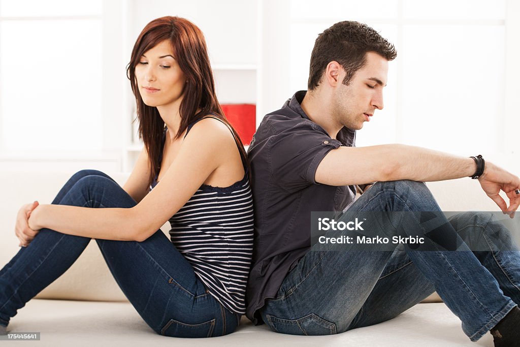 Couple Crisis Young couple sittin back to back on the sofa,having relationship difficulties 25-29 Years Stock Photo