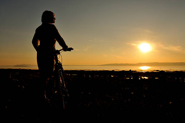 istock Woman cycling at sunset 175445984