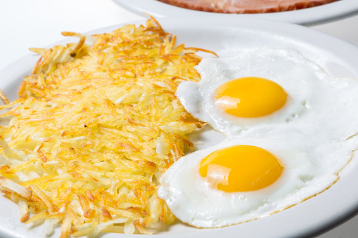 Over Easy Fried Eggs and Hash Browns Close up