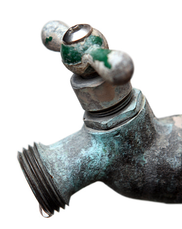 Close up of old, rusty faucet with dripping water