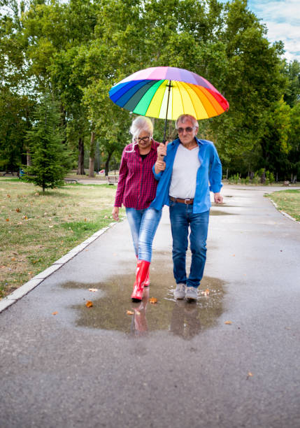 istock Couple under umbrella in autumn park 1754464797