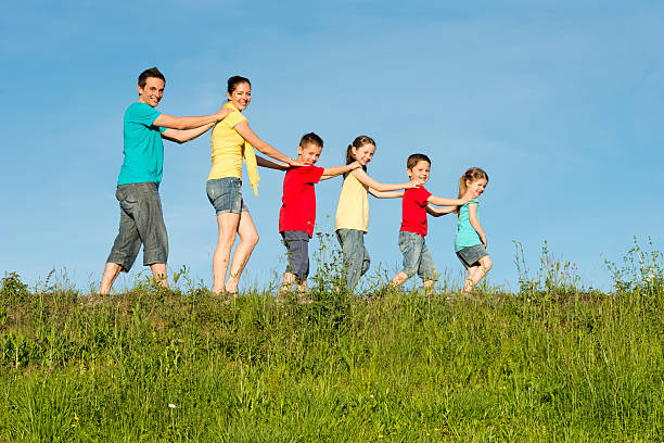 istock happy family walking in the grass 175446633