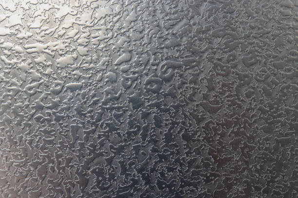 Abstract background of a gray metal surface.