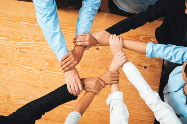 istock Multicultural business people holding hand together in circle. Habiliment 1754470834