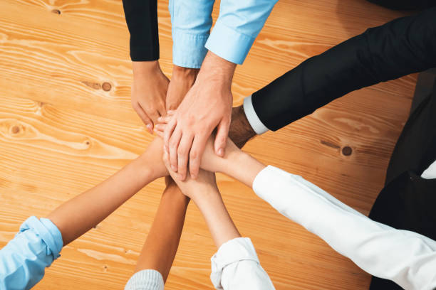 istock Multiracial business people make synergy hand stack together. Habiliment 1754471709