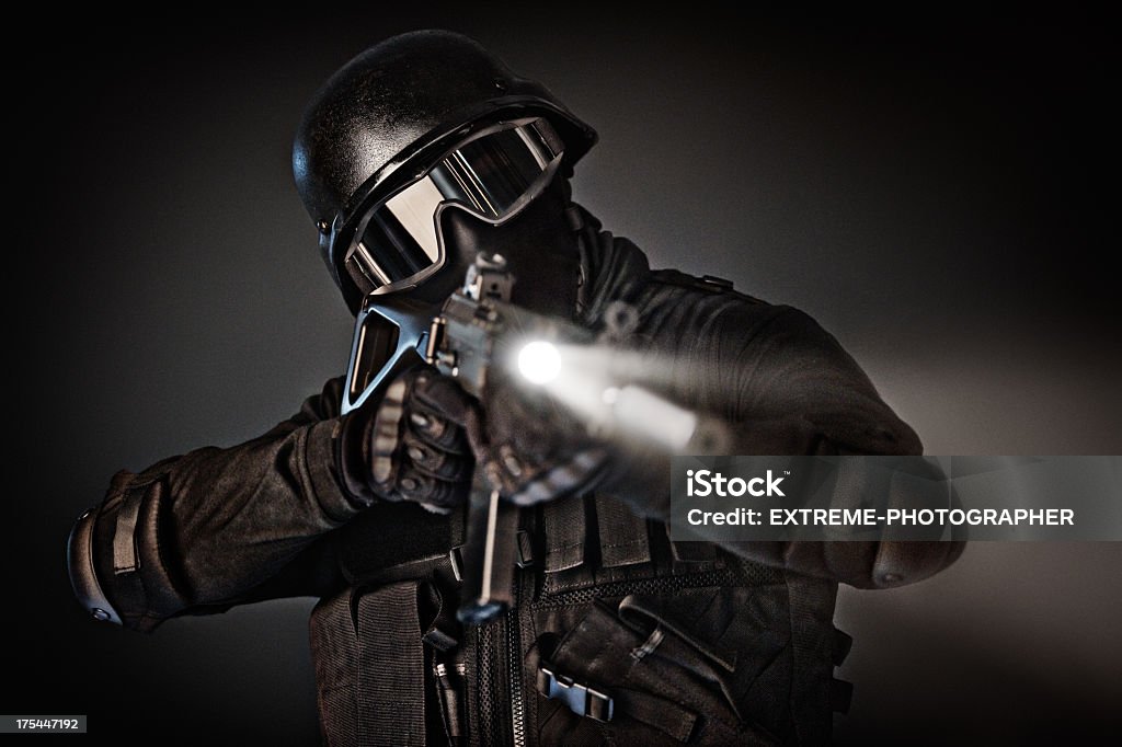 Negotiator Modern military soldier holding a rifle. Studio shot on black background. Target Shooting Stock Photo