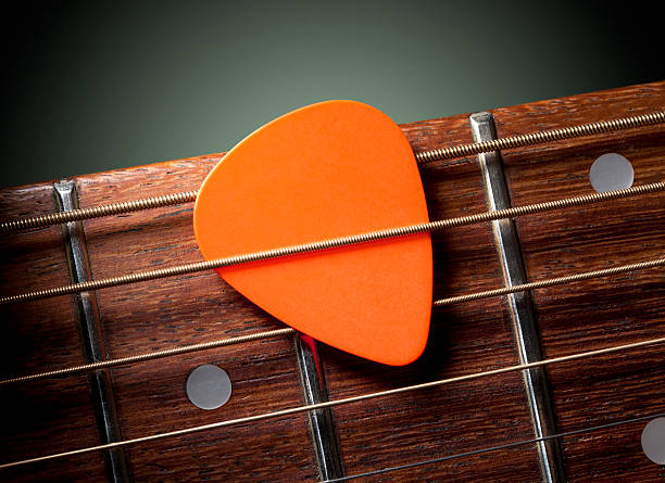 Acoustic guitar with pick Acoustic guitar with pick. Acoustic guitar with pick.Similar photographs from my portfolio: musical instrument string stock pictures, royalty-free photos & images
