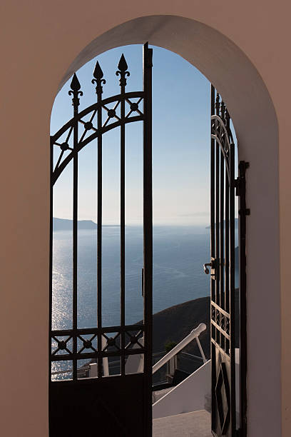 doorway to the mediterranean - fira, greece - santorini door sea gate bildbanksfoton och bilder