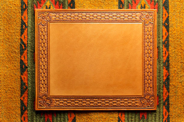 A western style stamped leather frame on a Native American style blanket.