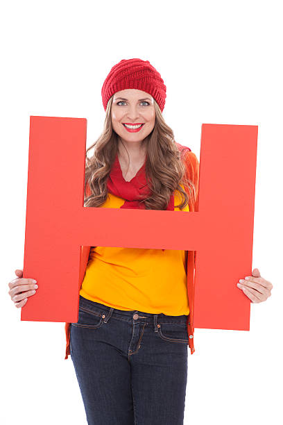 Woman holding letter H.