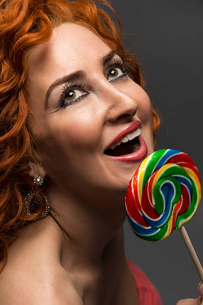 милый девушка - women lollipop old fashioned red hair стоковые фото и изображения