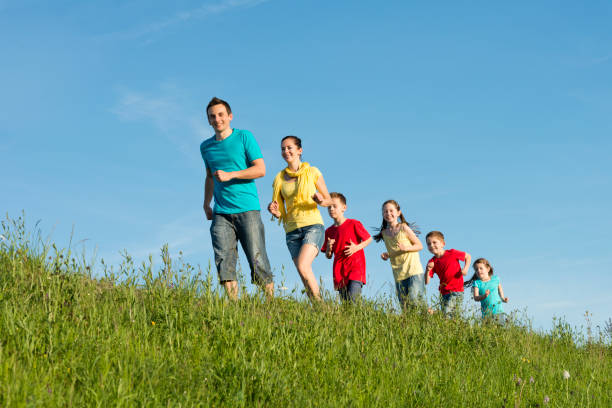 istock happy family jogging in the grass 175448317