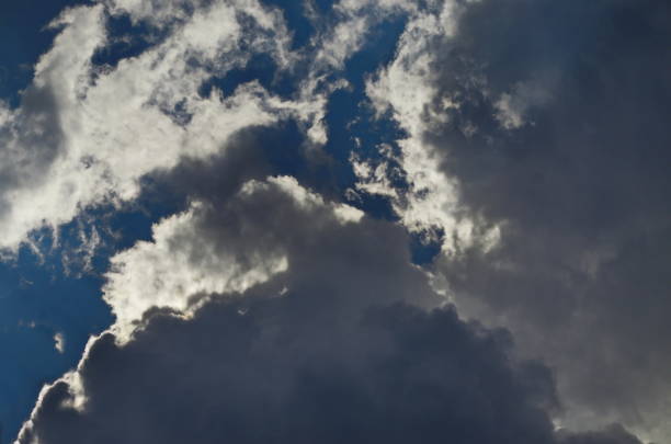 istock Background of rainy fluffy clouds floating on a bright blue sky 1754485122