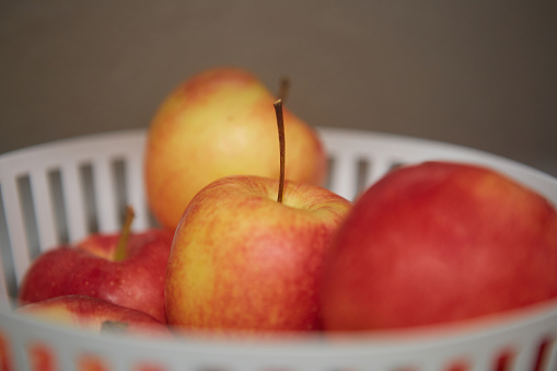 Metal fruit bowl full of apples