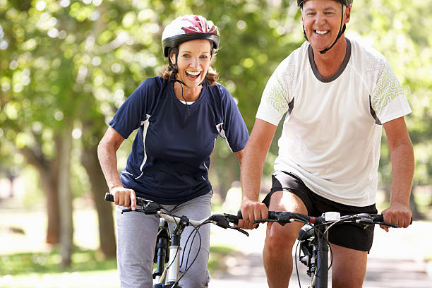 istock Middle aged couple bicycling together 175448697