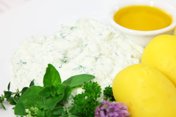 Bowl of sour cream with onion on blue background