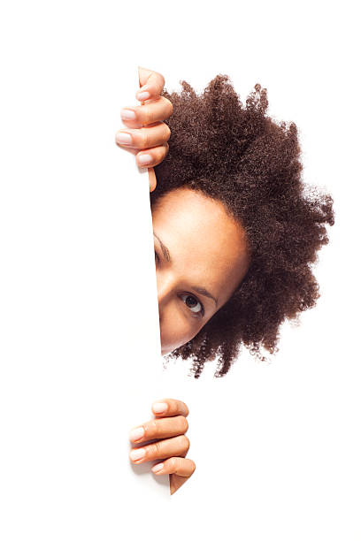 istock Woman peeking behind blank sheet 175449423