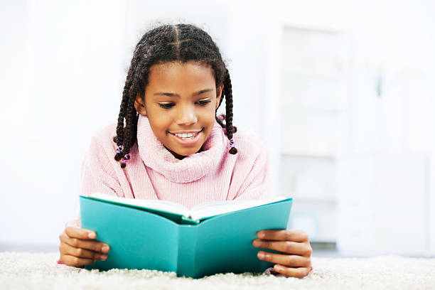 istock Young happy teenager reading a book 175449432