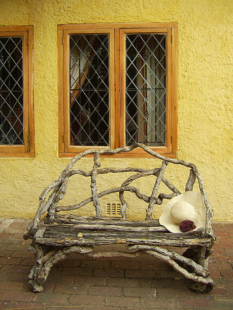 Hat, garden bench and windwo stock photo
