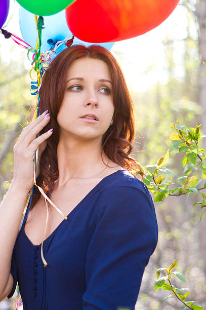 istock Sensual woman holding colourful balloons 175449868