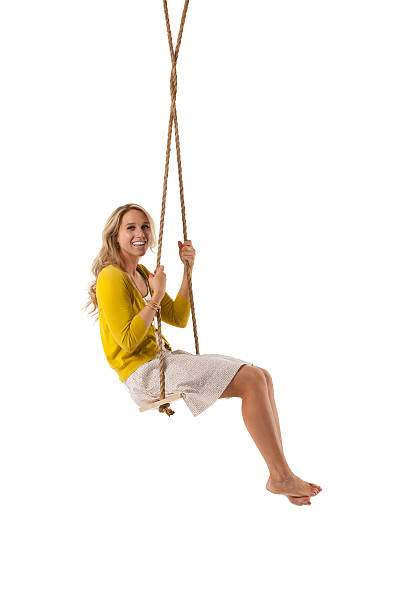 istock Happy attractive young woman posing on a swing 175451058