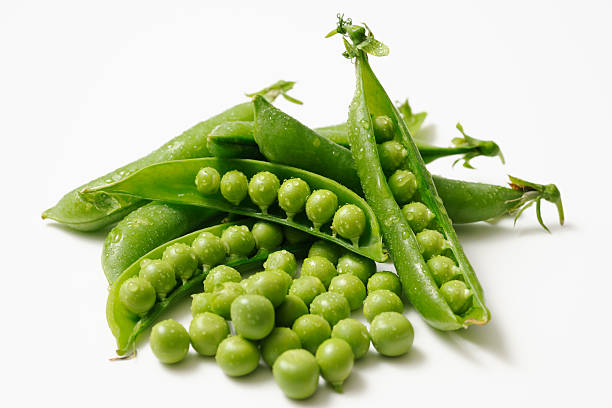 istock Opened fresh green peas with water droplets on white background 175451121