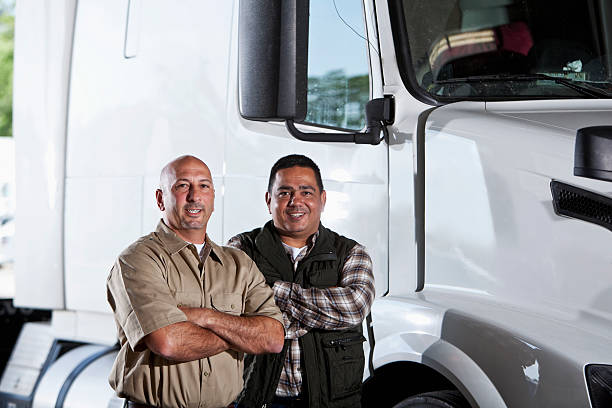 istock Multi-ethnic men standing next to semi-truck 175452712