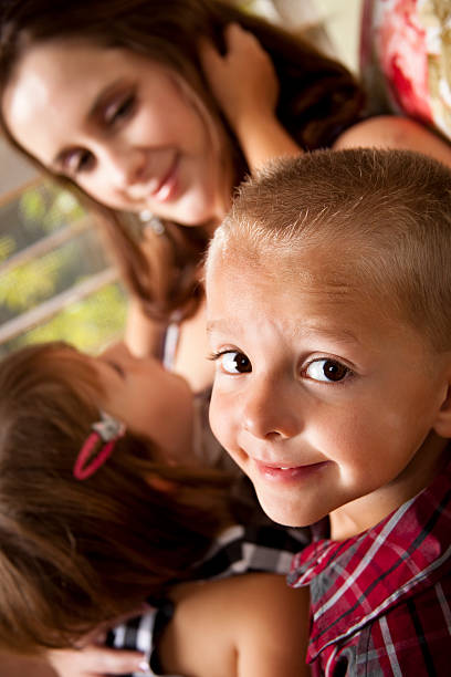istock Little boy looking at camera, family in background. 175453039