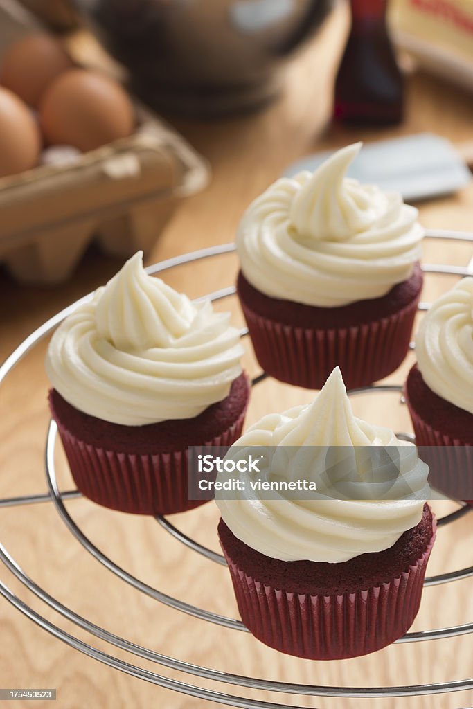 Baking Red Velvet Cupcakes Baking Red Velvet cupcakes with cream cheese frosting. The ingredients used to make the cupcakes are in the background. Cream Cheese Stock Photo