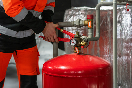 3d rendering fire extinguisher hanging on brick wall