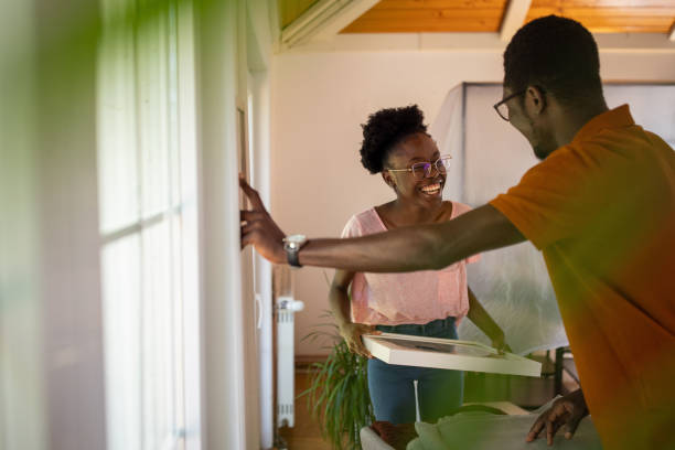 istock Couple hanging picture in new home 1754540255