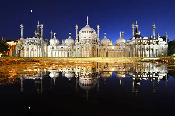 "The Brighton Pavilion by (with) Moonlight and floodlight reflected in an ornamental pondStraight time exposure photograph - no image manipulationThe Royal Pavilion is a former royal residence (now a public building) located in Brighton, England. It was built in three stages, beginning in 1787, as a seaside retreat for George, Prince of Wales, from 1811 Prince Regent. It is often referred to as the Brighton Pavilion."
