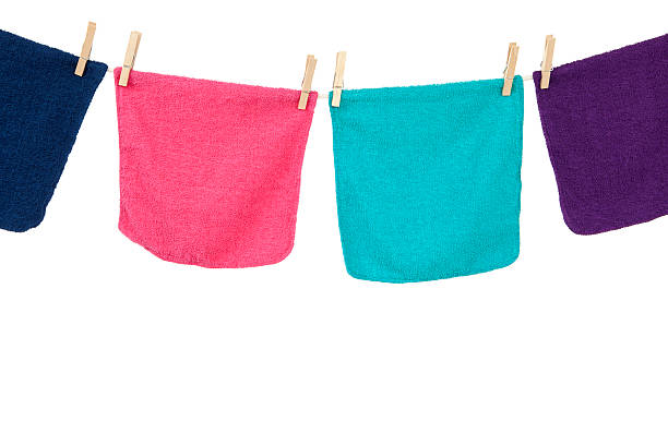 Colorful laundry hanging on a clothesline. Studio isolated on white.