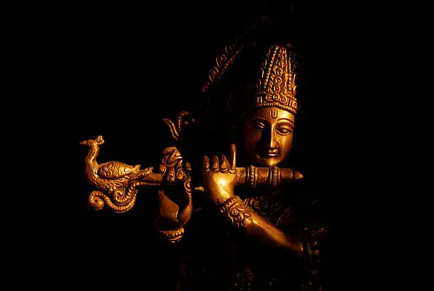Status of Hindu God - Krishna in direct Sunlight. Background cleaned and made black. Very slight grains in dark areas.