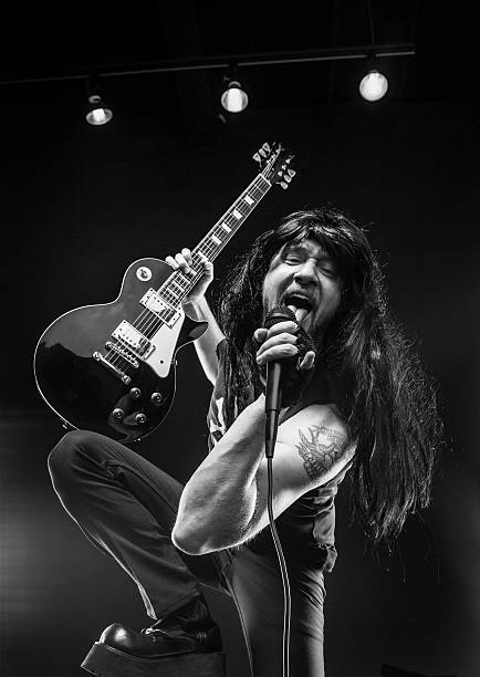 istock Black and White Rocker With Guitar in Boots Dark Background 175454593