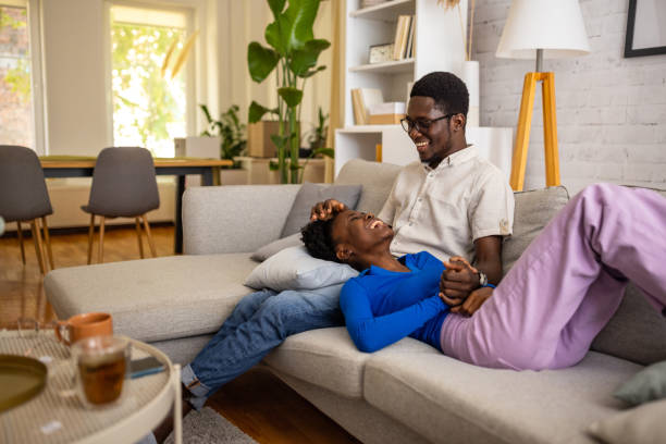 istock Happy couple relaxing on sofa 1754555243