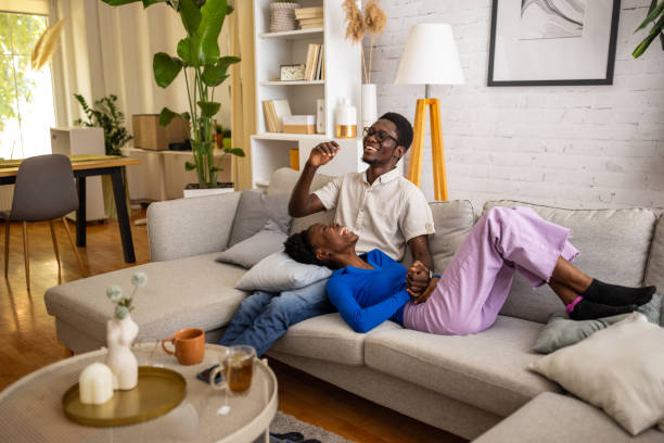 istock Happy couple relaxing on sofa 1754555283