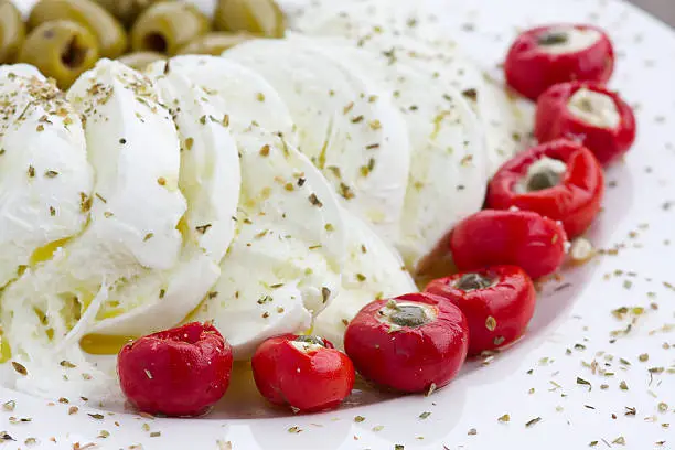 "Italian starter with buffalo mozzarella, olives and stuffed peppers"