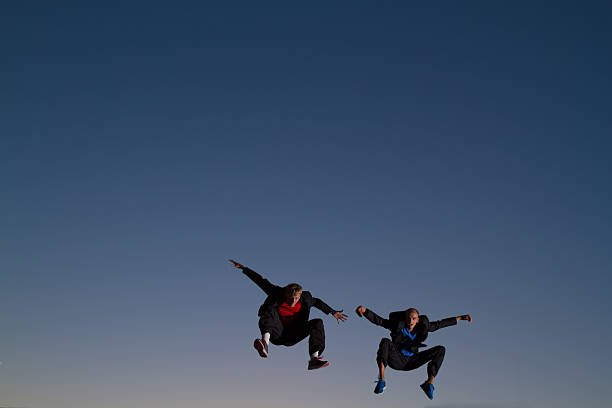istock Two men jumping doing martial arts on roof 175455574