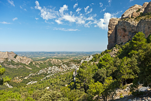 View over the Terra Alta plateau in the province of Tarragona in Catalonia, Spain. The rocky cliffs on the right belong to a rock formation called the Roques Benet.